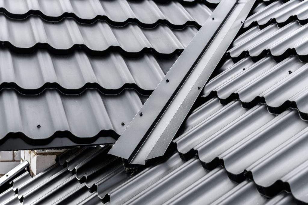 Construction of the roof of the house. Metal tiles.