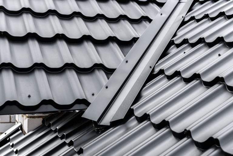 Construction of the roof of the house. Metal tiles.