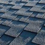 Close up view on asphalt roofing shingles covered with frost