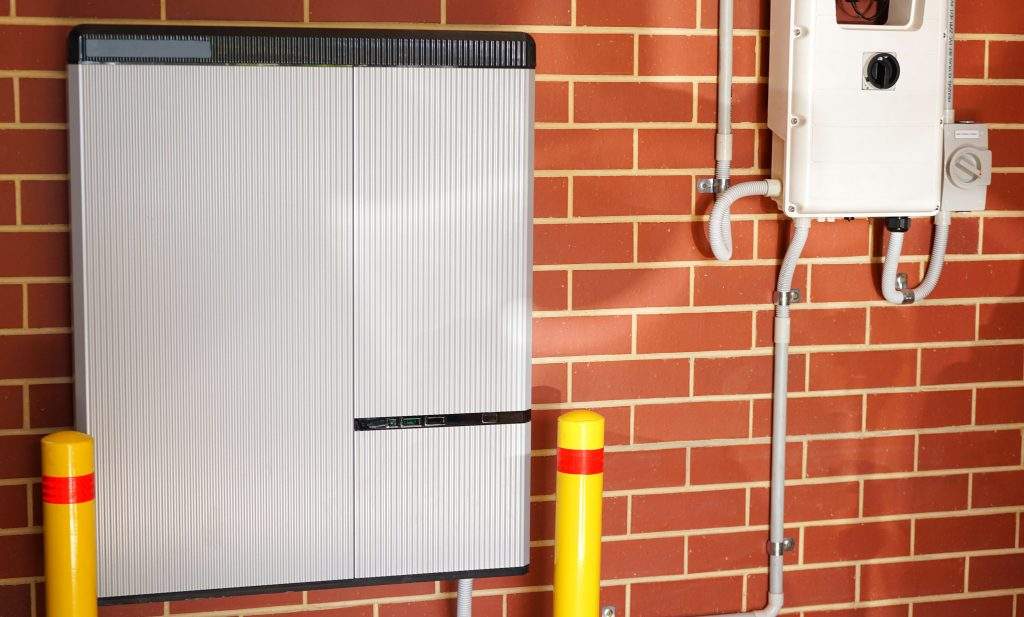 Lithium ion home battery and solar inverter solar panel system for domestic power storage installed in home garage.