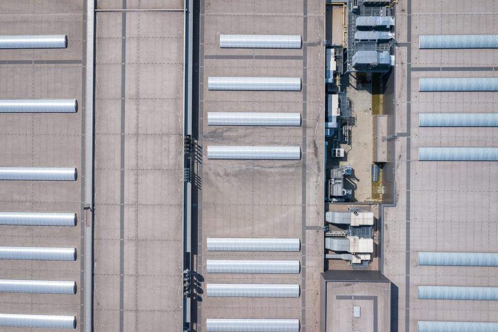 Industrial. Aerial view of large roof of factory.  Drone shot from above.