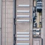 Industrial. Aerial view of large roof of factory.  Drone shot from above.