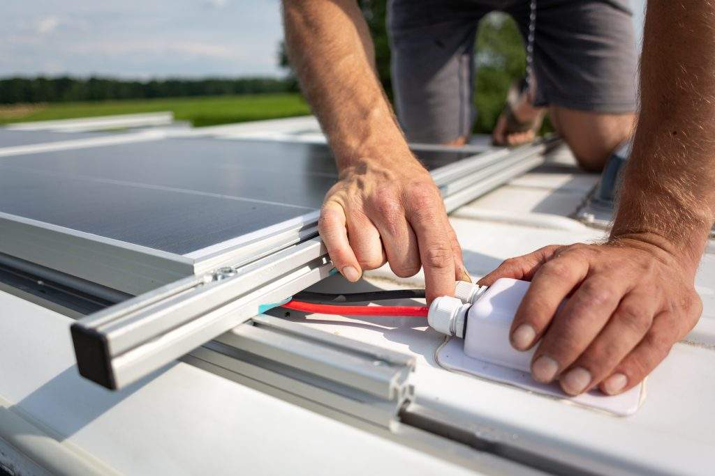 Solar panel connection cables on top of a camper van