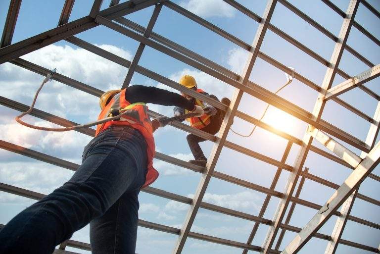 Construction workers install new roofs, roofing tools and fall protection devices. Apply to new roofRoof repair, a Specialist in Roof Forming, is the Replacement of roof plates