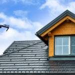 Drone in the air inspecting the roof over the house. Close-up of drone and roof.