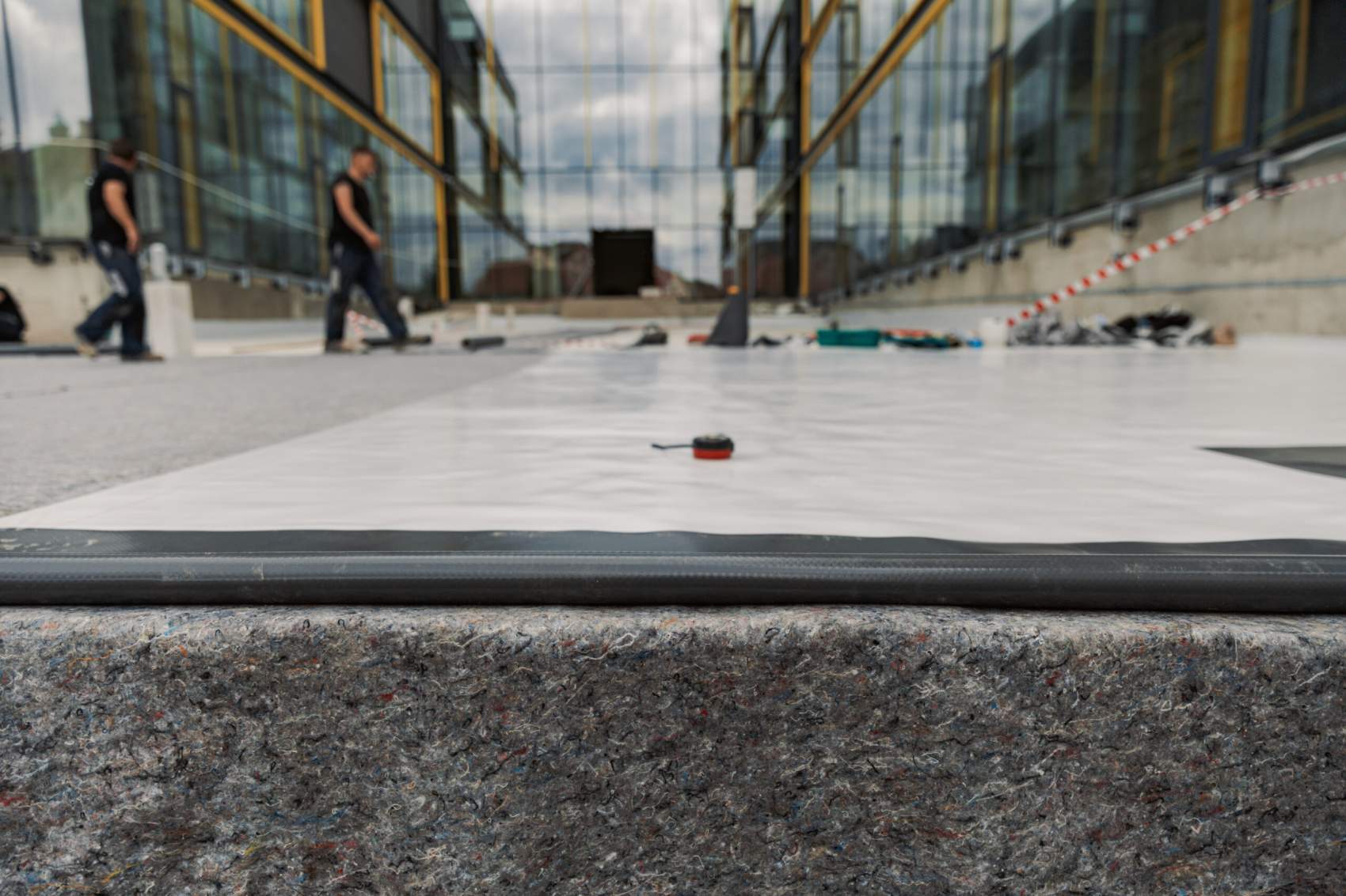 Waterproofing and insulation at construction site, waterproofing membrane preventing water penetration. Exterior vapor barrier for roof.